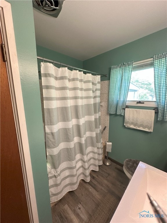 5916 E Benalex Dr, Toledo, OH 43612 - bathroom with wood finished floors, a shower with curtain, and vanity
