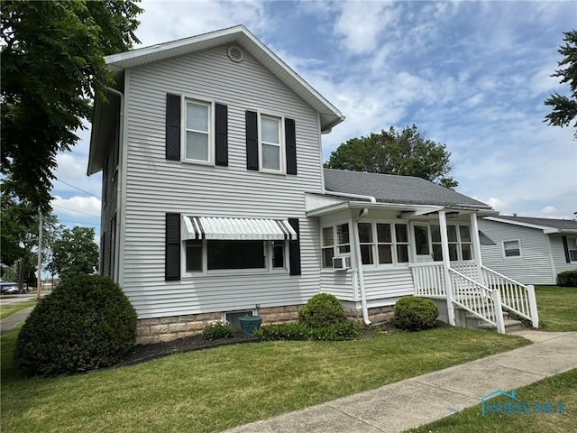 201 E Rings St, West Unity, OH 43570 - traditional home featuring a front yard, cooling unit, a sunroom, and roof with shingles