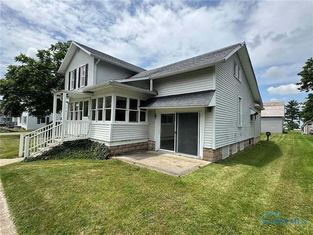 201 E Rings St, West Unity, OH 43570 - rear view of house featuring a lawn, roof with shingles, and a patio area