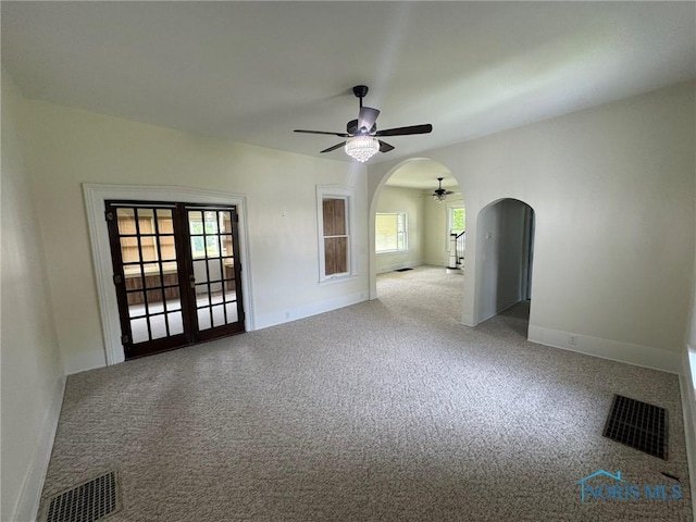 201 E Rings St, West Unity, OH 43570 - carpeted spare room with ceiling fan, arched walkways, and healthy amount of natural light