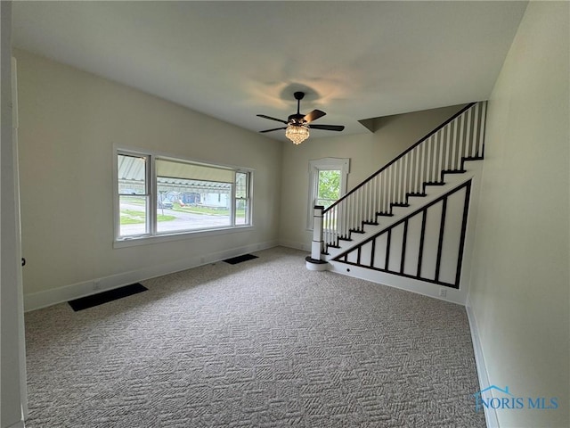 201 E Rings St, West Unity, OH 43570 - unfurnished living room with carpet floors, ceiling fan, and stairway