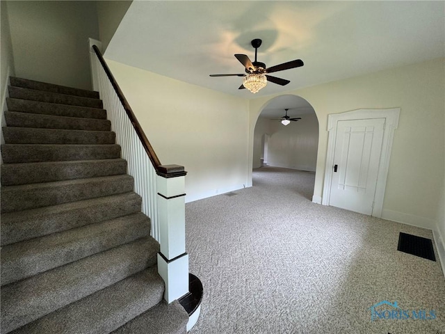 201 E Rings St, West Unity, OH 43570 - stairs with a ceiling fan, arched walkways, and carpet floors