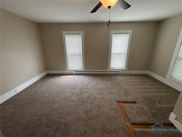 201 E Rings St, West Unity, OH 43570 - carpeted empty room with a baseboard radiator and ceiling fan