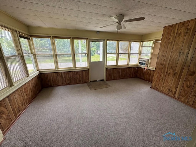 201 E Rings St, West Unity, OH 43570 - unfurnished sunroom featuring wood walls and carpet flooring
