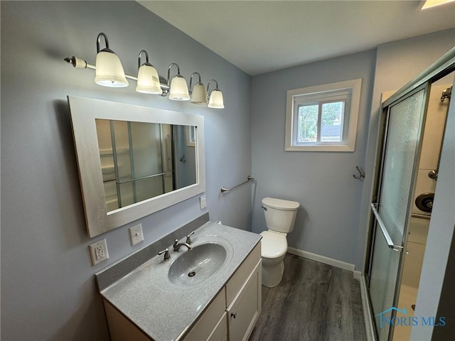 201 E Rings St, West Unity, OH 43570 - bathroom with vanity, wood finished floors, and a shower with shower door