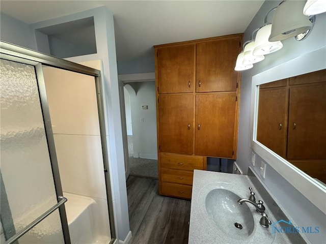 201 E Rings St, West Unity, OH 43570 - full bathroom with a stall shower, wood finished floors, and vanity