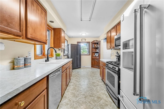 238 Richards Rd, Toledo, OH 43607 - kitchen with appliances with stainless steel finishes, brown cabinets, and light countertops
