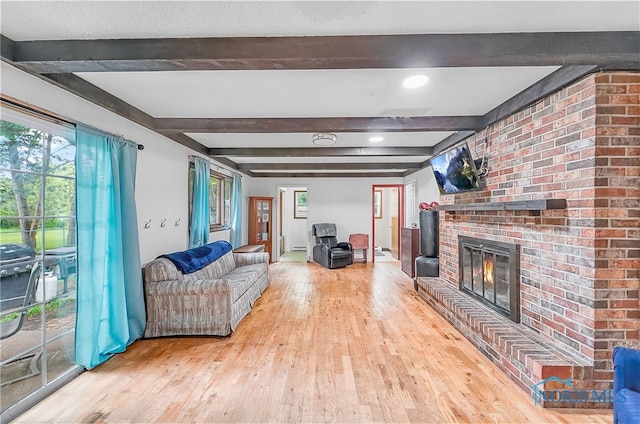 238 Richards Rd, Toledo, OH 43607 - living room featuring hardwood / wood-style floors, a brick fireplace, beamed ceiling, and baseboard heating
