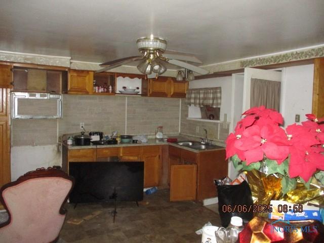 100 S Crissey Rd, Holland, OH 43528 - kitchen featuring a ceiling fan, brown cabinetry, light countertops, open shelves, and tasteful backsplash