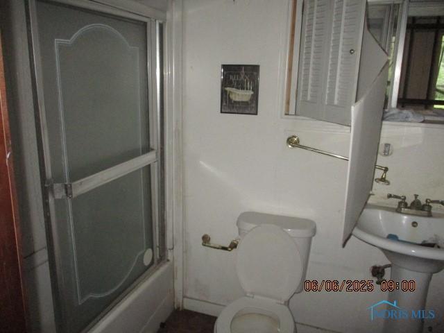 100 S Crissey Rd, Holland, OH 43528 - bathroom with toilet and combined bath / shower with glass door