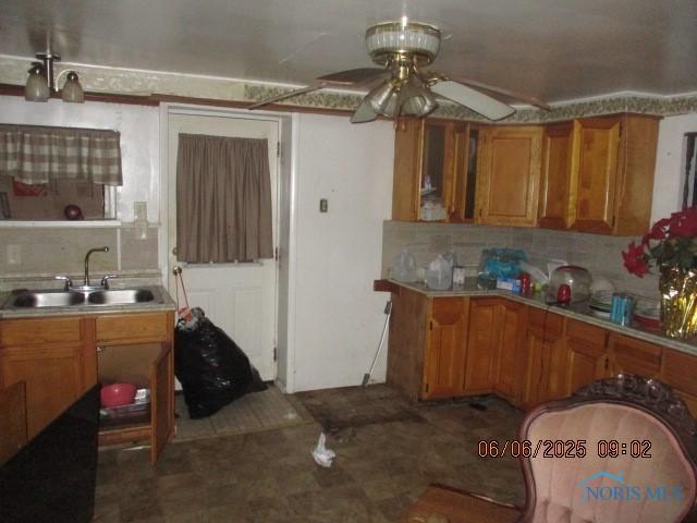 100 S Crissey Rd, Holland, OH 43528 - kitchen featuring brown cabinets, ceiling fan, backsplash, and light countertops