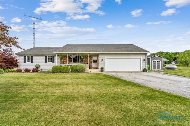 4220 N County Road 33, Tiffin, OH 44883 - ranch-style home with covered porch, asphalt driveway, a garage, a front lawn, and a shed