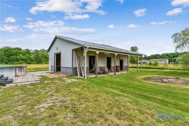 4220 N County Road 33, Tiffin, OH 44883 - rear view of house with an outbuilding, a metal roof, and a detached garage