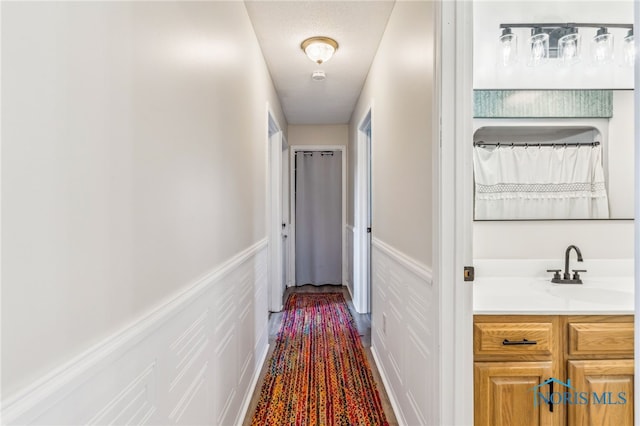 4220 N County Road 33, Tiffin, OH 44883 - hallway featuring a wainscoted wall and a decorative wall