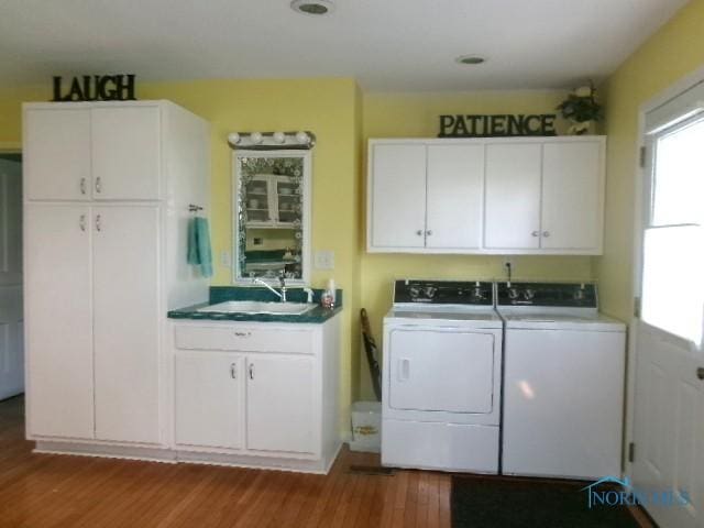252 N Walnut St, Ottawa, OH 45875 - laundry area with cabinet space, washer and dryer, and wood finished floors