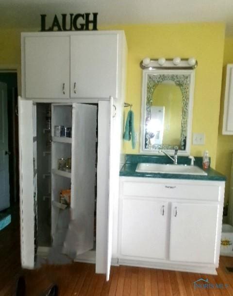 252 N Walnut St, Ottawa, OH 45875 - kitchen with light wood-type flooring and white cabinets