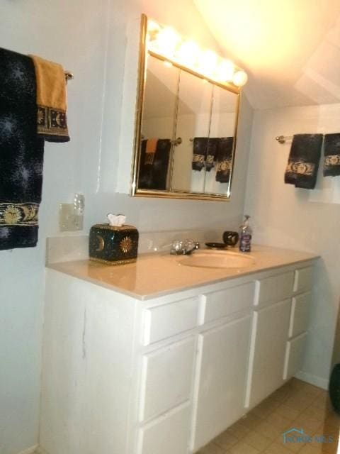 252 N Walnut St, Ottawa, OH 45875 - bathroom featuring vanity, tile patterned floors, and lofted ceiling