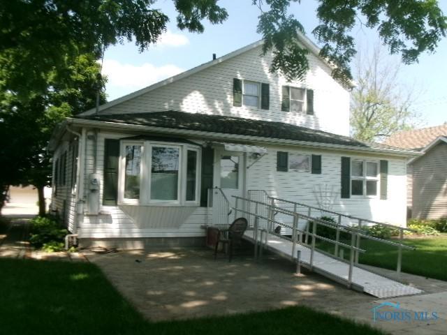 252 N Walnut St, Ottawa, OH 45875 - rear view of house featuring a yard