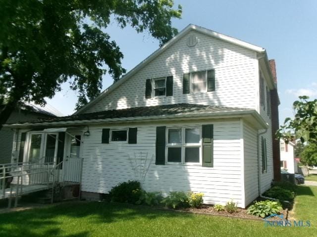 252 N Walnut St, Ottawa, OH 45875 - rear view of property featuring a yard and a chimney