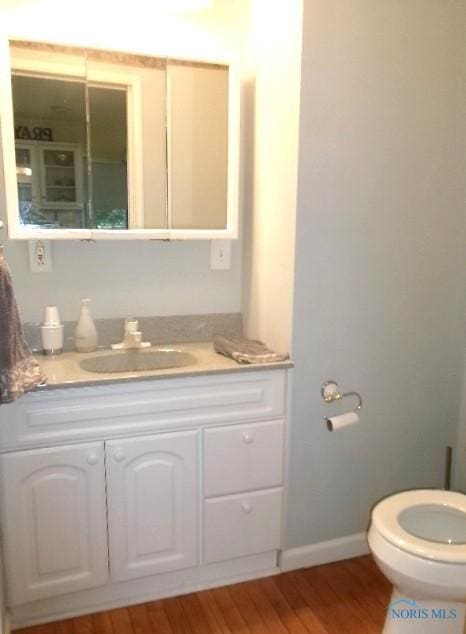 252 N Walnut St, Ottawa, OH 45875 - bathroom featuring vanity and wood finished floors