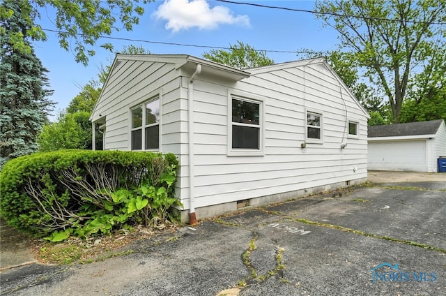 1022 Clough St, Bowling Green, OH 43402 - view of side of home featuring crawl space and an outbuilding