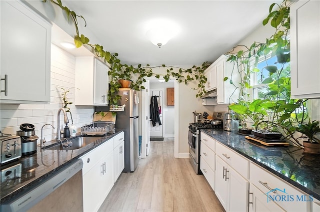 1022 Clough St, Bowling Green, OH 43402 - kitchen with appliances with stainless steel finishes, under cabinet range hood, backsplash, and white cabinetry