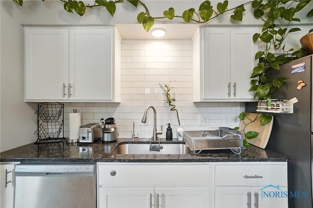 1022 Clough St, Bowling Green, OH 43402 - kitchen with appliances with stainless steel finishes, white cabinets, decorative backsplash, and dark stone countertops