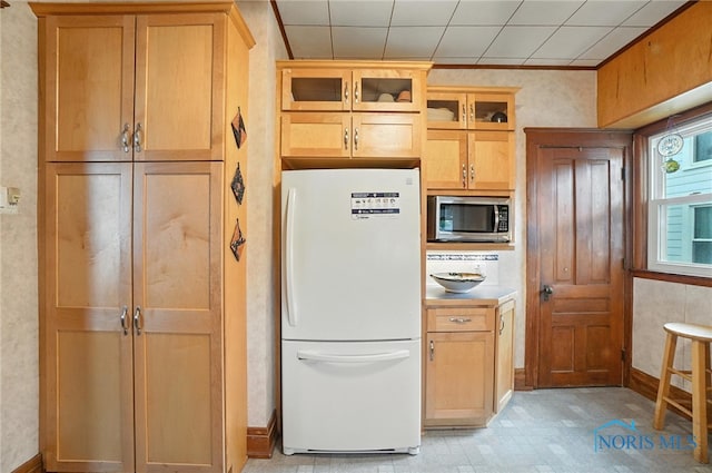 418 S Grove St, Bowling Green, OH 43402 - kitchen with freestanding refrigerator, stainless steel microwave, glass insert cabinets, and crown molding
