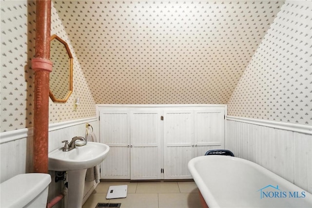 418 S Grove St, Bowling Green, OH 43402 - full bath with a freestanding bath, wallpapered walls, a wainscoted wall, and tile patterned floors