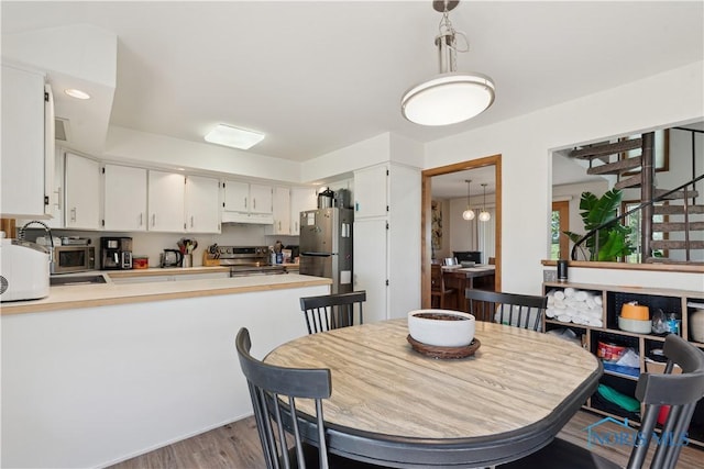 23866 W State Route 579, Curtice, OH 43412 - dining area featuring wood finished floors and stairs