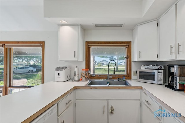 23866 W State Route 579, Curtice, OH 43412 - kitchen with white appliances, light countertops, plenty of natural light, and white cabinetry