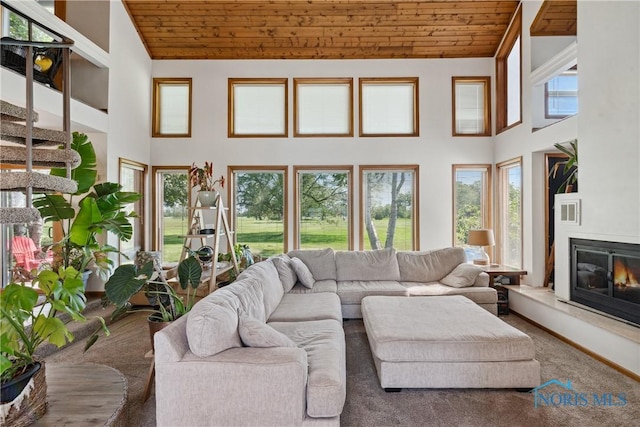 23866 W State Route 579, Curtice, OH 43412 - carpeted living room with wooden ceiling, high vaulted ceiling, and a glass covered fireplace