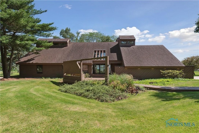 23866 W State Route 579, Curtice, OH 43412 - back of house with a lawn and a shingled roof