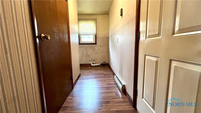 825 Johnson Rd, Paulding, OH 45879 - corridor with baseboard heating, dark wood-type flooring, and a wainscoted wall