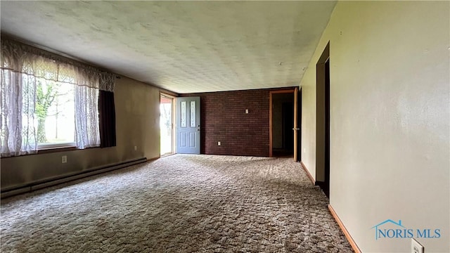 825 Johnson Rd, Paulding, OH 45879 - carpeted empty room featuring a baseboard heating unit and baseboards