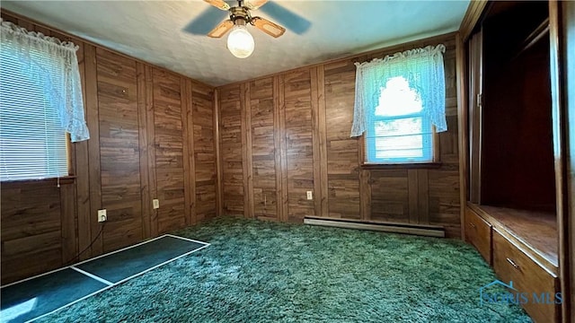 825 Johnson Rd, Paulding, OH 45879 - doorway to outside with a baseboard heating unit, carpet floors, wood walls, and ceiling fan