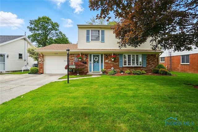 1309 Gettysburg Dr, Maumee, OH 43537 - traditional-style home featuring an attached garage, concrete driveway, a front lawn, and brick siding