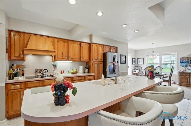 1309 Gettysburg Dr, Maumee, OH 43537 - kitchen featuring custom range hood, stainless steel fridge, brown cabinetry, light countertops, and recessed lighting
