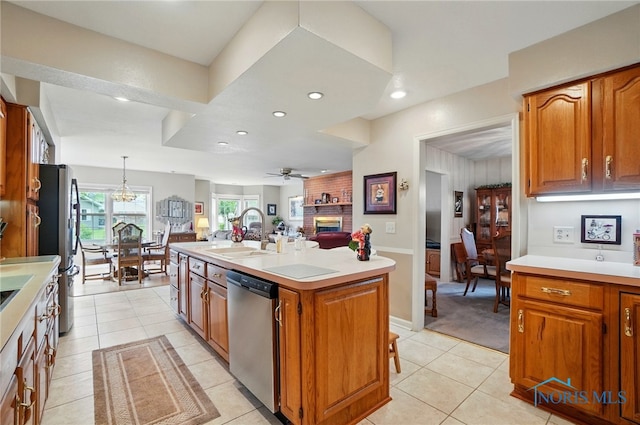 1309 Gettysburg Dr, Maumee, OH 43537 - kitchen with appliances with stainless steel finishes, a center island with sink, light countertops, open floor plan, and ceiling fan