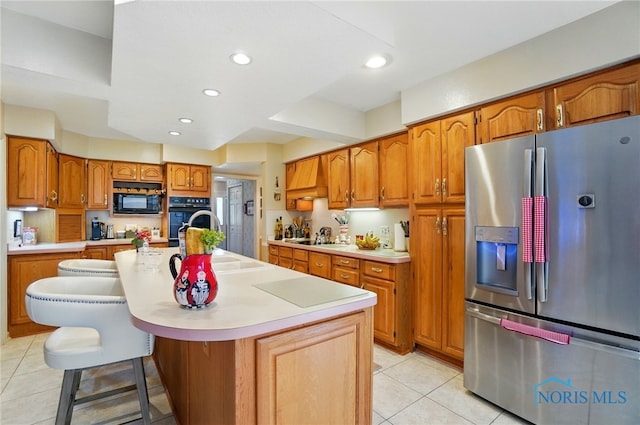1309 Gettysburg Dr, Maumee, OH 43537 - kitchen featuring stainless steel fridge with ice dispenser, light tile patterned flooring, black microwave, brown cabinetry, and light countertops