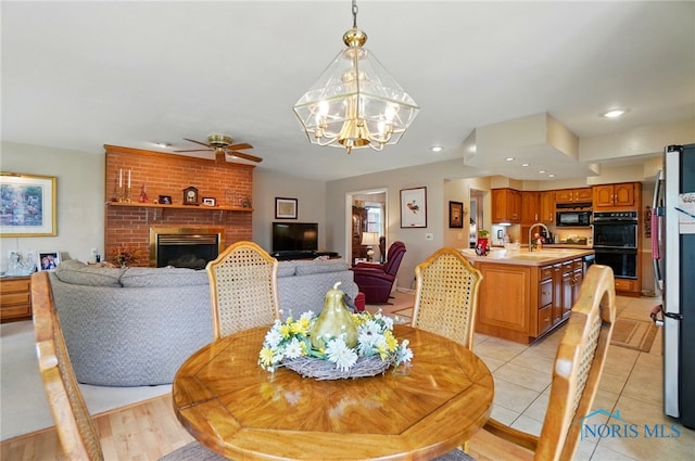 1309 Gettysburg Dr, Maumee, OH 43537 - dining space with ceiling fan, a chandelier, recessed lighting, light tile patterned flooring, and a fireplace