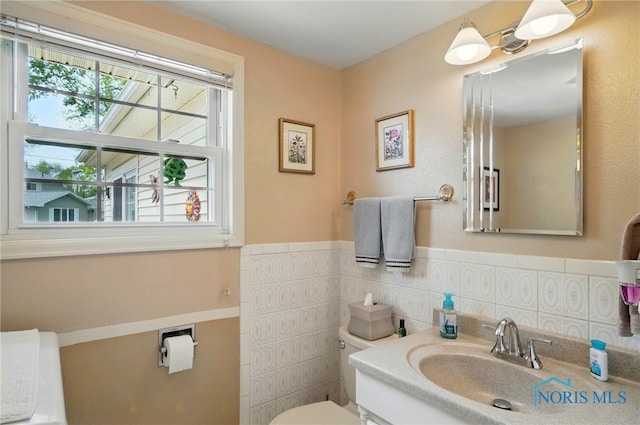 1309 Gettysburg Dr, Maumee, OH 43537 - bathroom featuring vanity, a wainscoted wall, and tile walls