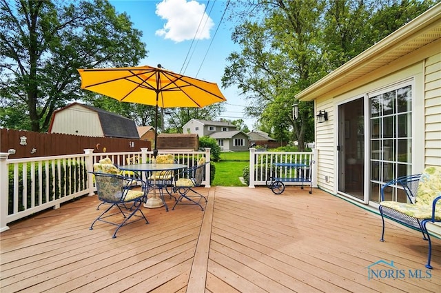 1309 Gettysburg Dr, Maumee, OH 43537 - wooden deck featuring outdoor dining space and a storage shed