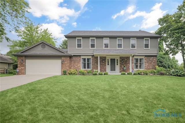 7040 Country Creek Rd, Maumee, OH 43537 - view of front facade featuring brick siding, a garage, a front yard, and concrete driveway