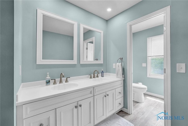 7040 Country Creek Rd, Maumee, OH 43537 - full bathroom featuring double vanity and wood finished floors