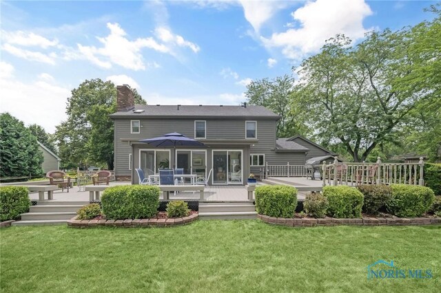 7040 Country Creek Rd, Maumee, OH 43537 - back of house with a chimney, a wooden deck, and a lawn