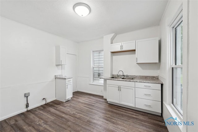 2336 Caledonia St, Toledo, OH 43605 - kitchen featuring dark wood-style flooring, white cabinets, and a textured ceiling