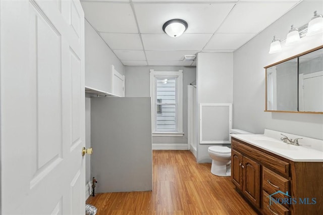 2336 Caledonia St, Toledo, OH 43605 - full bathroom with a drop ceiling, vanity, a shower with shower curtain, and wood finished floors