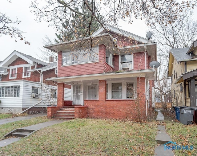 433 Islington St, Toledo, OH 43610 - view of front of home with brick siding, a front lawn, cooling unit, and covered porch