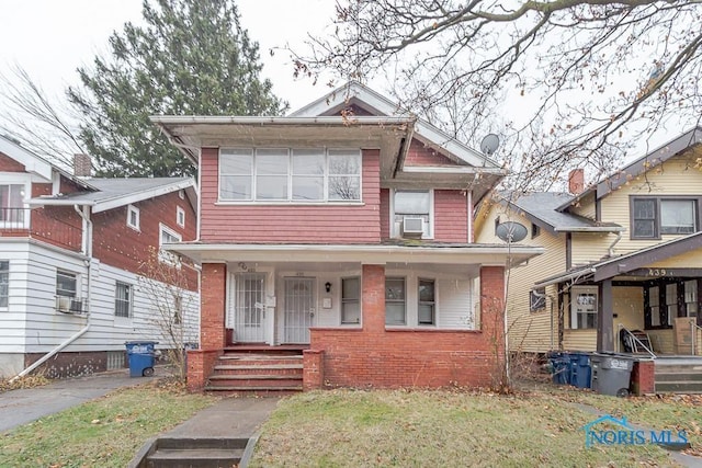 433 Islington St, Toledo, OH 43610 - view of front of house with a porch, a front lawn, and cooling unit